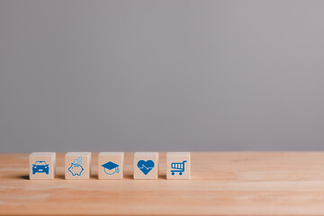 Wooden blocks with icons of various types of insurance. Life insurance concept.