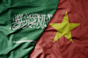 big waving realistic national colorful flag of saudi arabia and national flag of vietnam .