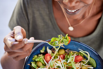 African american woman eating fresh healthy salad