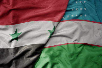 big waving realistic national colorful flag of syria and national flag of uzbekistan .
