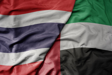big waving realistic national colorful flag of thailand and national flag of united arab emirates .