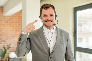 smiling cheerfully, feeling happy and showing a concept. telemarketer concept