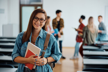 Portrait of happy female student at university looking at camera.