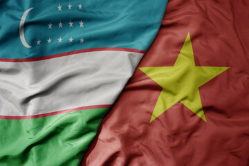 Fototapeta premium big waving realistic national colorful flag of uzbekistan and national flag of vietnam .