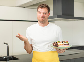 shrugging, feeling confused and uncertain. home made cakes concept