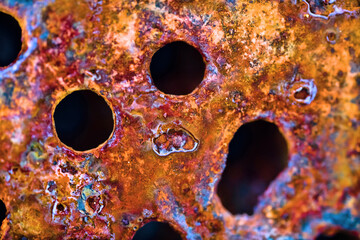 The surface of rusty iron with drilled holes for bolts. Ultra Macro background - obrazy, fototapety, plakaty