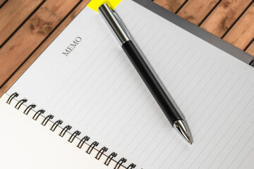 Closeup of notepad on wooden table in empty conference room.