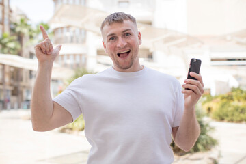 feeling like a happy and excited genius after realizing an idea. smartphone concept