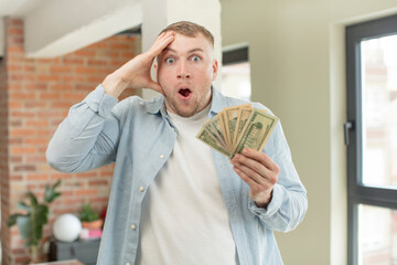 looking happy, astonished and surprised. dollar banknotes concept