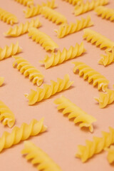 Pattern made of pasta on beige background. Close-up. Macro photo. Food concept. 