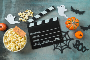 Horror movie night and Halloween party concept with  popcorn, pumpkin and movie clapper board on...