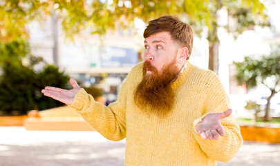red hair bearded man feeling puzzled and confused, unsure about the correct answer or decision,...
