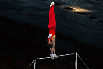 gymnast exercise horizontal bar in championship gymnastics, element handstand