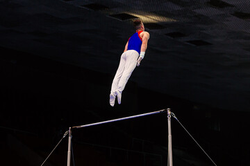 gymnast exercise horizontal bar in championship gymnastics, flying man concept