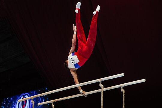 gymnast exercise parallel bars in championship gymnastics