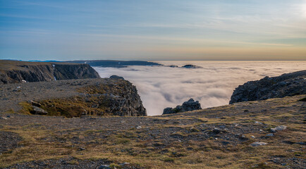 Obraz premium Rocky cliff and wonderful view of the clouds below