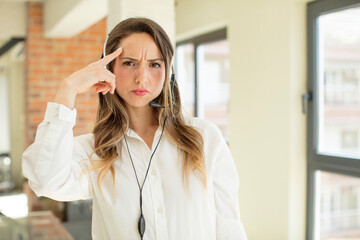 pretty woman looking surprised, realizing a new thought, idea or concept. telemarketer concept