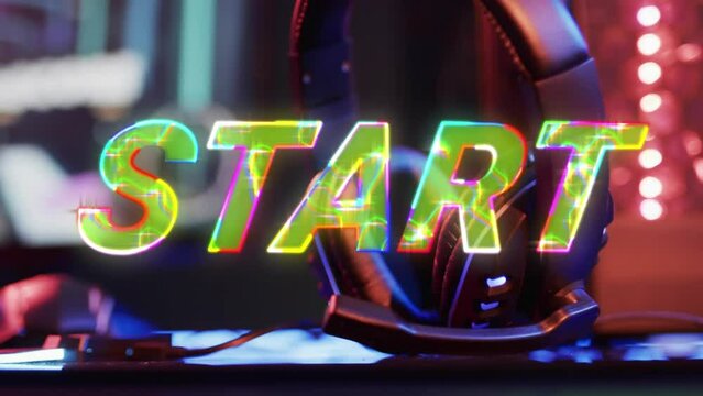 Animation of start text over video game equipment on neon background