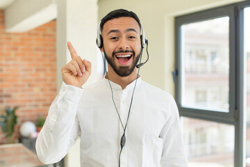 young  adult man feeling like a happy and excited genius after realizing an idea. telemarketer concept