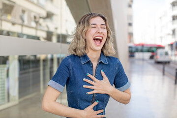Fototapeta premium pretty woman laughing out loud at some hilarious joke, feeling happy and cheerful, having fun