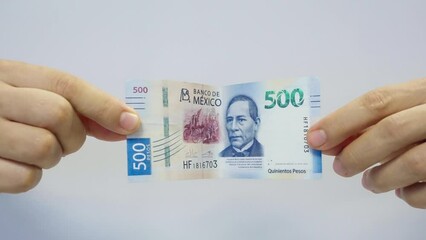 Male Hands Showing 500 Mexican Pesos Bill