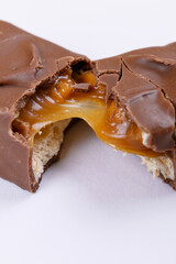 Sweet chocolate bar broken into two pieces. Macro photo.