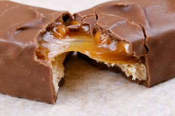 Sweet chocolate bar broken into two pieces. Macro shot.