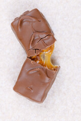 Chocolate bar with caramel fillings. Sweet chocolate bar broken into two pieces. Top view.