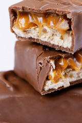 Chocolate bar with caramel fillings. Sweet chocolate bar broken into two pieces. Macro shot.