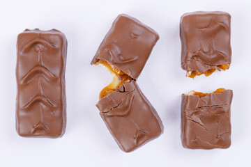 Whole, fracture and broken into two pieces chocolate bars. Top view.