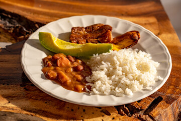 "bandeja paisa" bean dish with rice, chorizo, avocado and ripe plantain