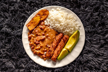 "bandeja paisa" bean dish with rice, chorizo, avocado and ripe plantain © Daniel Ching