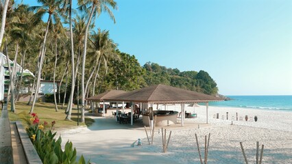 Romantic beach resort with turquoise water, white sand, and lush trees. Exclusive sunny holidays on a beautiful island in Thailand, perfect for summer vacation and relaxation.