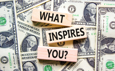 What inspires you symbol. Concept words What inspires you on wooden block. Dollar bills. Beautiful...