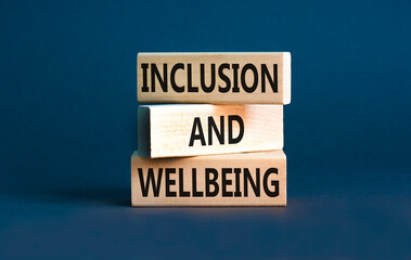 Inclusion and wellbeing symbol. Concept words Inclusion and wellbeing on wooden block. Beautiful grey table grey background. Motivational inclusion and wellbeing concept. Copy space.