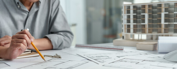 Interior architect working with blueprint planning in modern office, engineering concept. . - obrazy, fototapety, plakaty