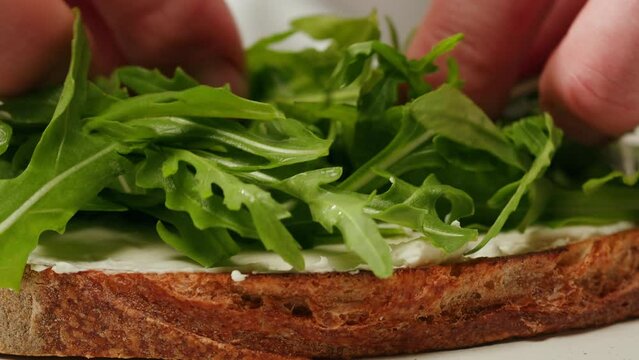 American sandwich, spreading butter cream cheese, chef cooking Famous thick cut sous vide beef sandwich on restaurant cafe kitchen. Bread with curd cheese. Studio shot close up.