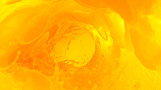 Splashing orange juice creating twister shape.
