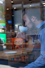 Young handsome man drinking coffee