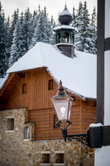 Lamp and snowy wooden house at Modrava, Sumava national park