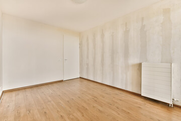 Obraz premium an empty room with wood floor and wallpapers on the walls that have been stripped down to white paint