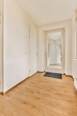 an empty room with wood flooring and white walls on either side of the room, there is a large mirror in the corner