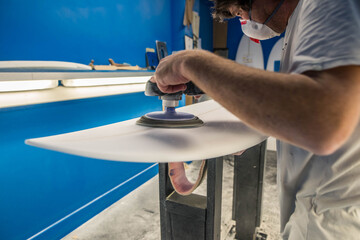 Professional surf shaper in action in his studio