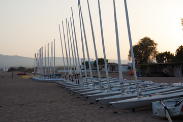 Boats, dinghies and catamarans lined up on a beach in Messini, Greece