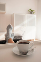 A cup of coffee with smoke on a tray. International coffee day.