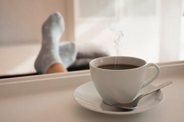 A cup of coffee with smoke on a tray. International coffee day.