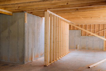 House with wooden framework frame that is under construction is supported by beams during construction process