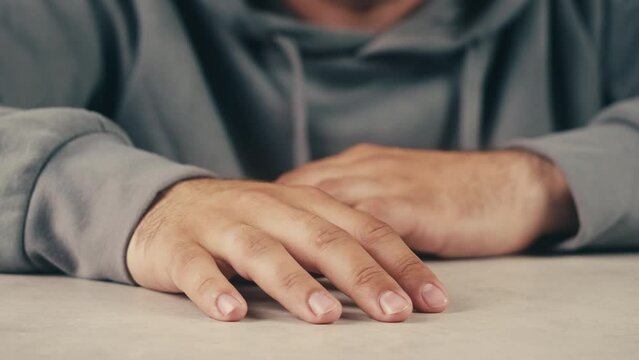 Schizophrenia patient doing a psychological test in a psychiatric clinic. Writing doodle in notebook nervously , shaking hands, tremor. Psychiatry patient hands close up , macro.