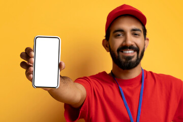 Indian Courier Guy Showing Smartphone With Blank Screen, Recommending Delivery Service App