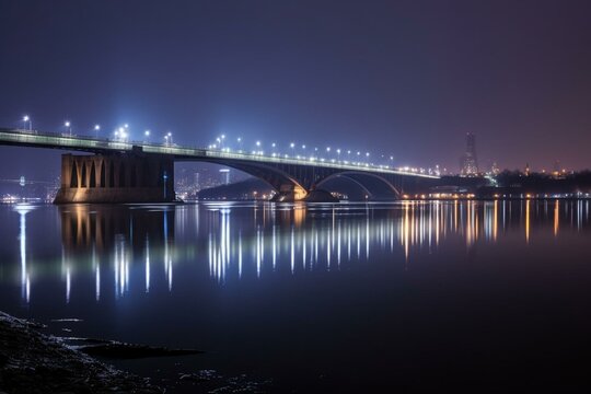 A lit bridge over water at night with a city in the background. Generative AI